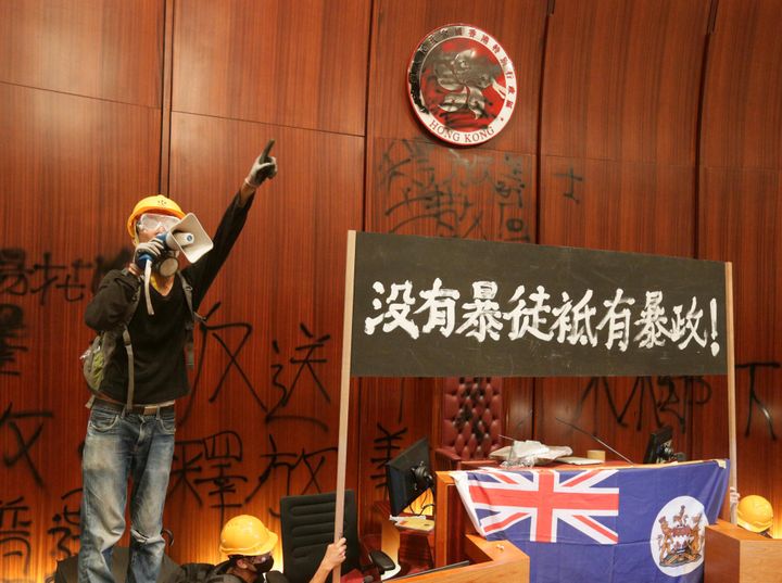 Un militant pro-démocratie à la tribune du Conseil législatif, à Hong-Kong, le 1er juillet 2019. (JUN YASUKAWA / THE YOMIURI SHIMBUN VIA AFP)