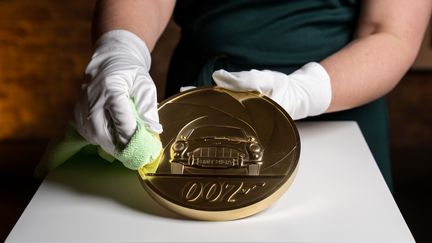 La pièce de 7kg réalisée par la Monnaie royale britannique sur laquelle figure la légendaire Aston Martin de l'agent secret 007. (AFP / ROYAL MINT)