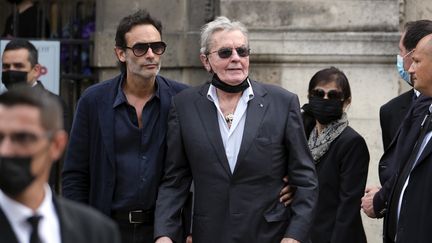 L'acteur Alain Delon, entouré de son fils, Anthony (à gauche), et de sa "dame de compagnie" Hiromi Rollin (au second plan), lors des funérailles de Jean-Paul Belmondo, le 10 septembre 2021, dans l'église de Saint-Germain-des-Prés, à Paris. (LAURENT VITEUR / GETTY IMAGES EUROPE)