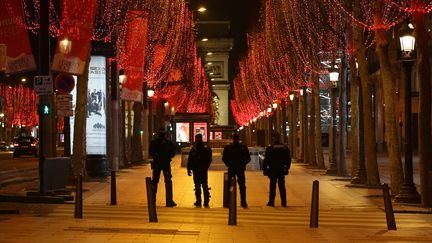 Des policiers sur les Champs-Elysées, à Paris, le 31 décembre 2020. (STEFANO RELLANDINI / AFP)