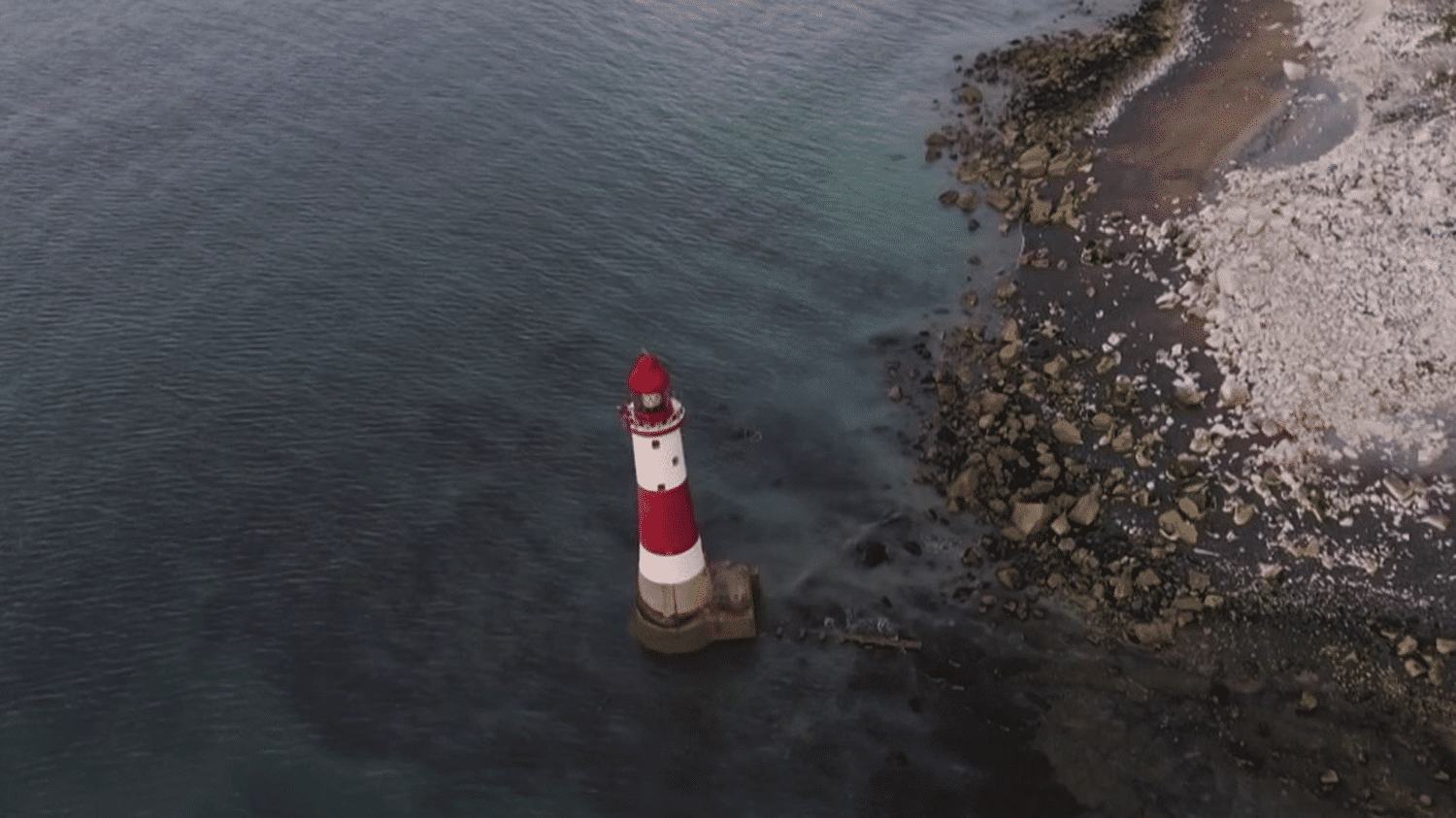 United Kingdom: Exploring Beachy Head Lighthouse, shaded by limestone cliffs