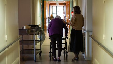 Une résidente d'un Ephad marche dans un couloir de l'établissement, le 31 décembre 2020 à Excideuil (Dordogne).&nbsp; (ROMAIN LONGIERAS / HANS LUCAS / AFP)