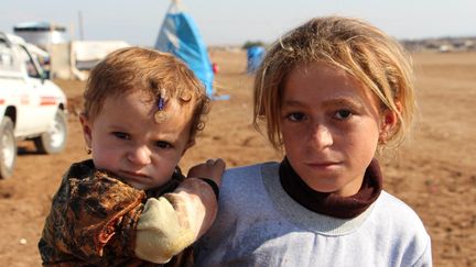 Des r&eacute;fugi&eacute;s y&eacute;zidis qui ont fui l'Etat islamique en Irak, le 28 novembre 2014 &agrave; Al-Hasakah (Syrie). (AHMED IBRAHIM / ANADOLU AGENCY / AFP)