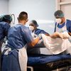 Des soignants portent un patient atteint du Covid-19 placé sous assistance respiratoire dans une chambre de l'unité de soins intensifs du Centre hospitalier universitaire de Pointe-à-Pitre (Guadeloupe), le 3 septembre 2021. (CARLA BERNHARDT / AFP)