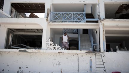 Une femme devant sa maison, détruite par l'ouragan Irma à Grand-Case, sur l'île de Saint-Martin, le 11 septembre 2017. (MARTIN BUREAU / AFP)