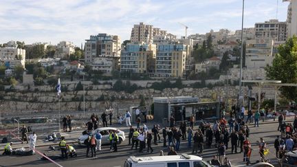 Des policiers et des secouristes israéliens inspectent le lieu d'une attaque à l'arme à feu à Jérusalem, le 30 novembre 2023. (MENAHEM KAHANA / AFP)