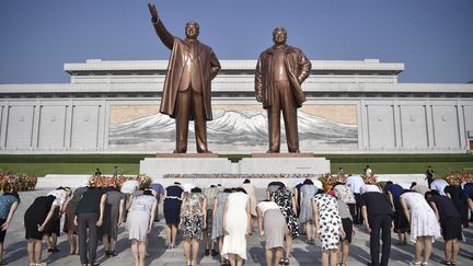 North Koreans pay their respects at statues of former leaders Kim Il-Sung and Kim Jong-II in Pyongyang on August 15, 2024. (KIM WON JIN / AFP)