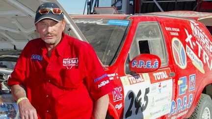 Johnny Hallyday lors de sa participation au Paris-Dakar, le 6 janvier 2002 à Atar, en Mauritanie.&nbsp; (PATRICK HERTZOG / AFP)