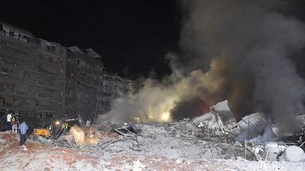 Des décombres fumants sur le site d'un bombardement massif israélien sur des immeubles de Beyrouth (Liban), le 27 septembre 2024. (HOUSSAM SHBARO / ANADOLU / AFP)