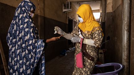 Mosquée de Ouagadougou - Burkina Faso
A l'entrée du lieu de prière réservé aux femmes, le "pagb misri", l'une d'entre elles distribue du gel hydroalcoolique. La Fédération burkinabè des associations islamiques a annoncé la suspension des prières entre le 21 mars et le 4 avril. Alors que le pays connaît une progression du nombre de cas, le milieu hospitalier&nbsp;s'est aussi réjoui de quelques guérisons.
 (OLYMPIA DE MAISMONT / AFP)