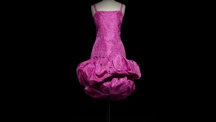 Medrano. En donnant à une robe fuchsia le nom d’un cirque, Yves Saint Laurent révèle l’une de ses grandes inspiratrices : Elsa Schiaparelli. Son rose shocking lancé en 1936 sera l’un de ses talismans chromatiques, symbole de fête et de joie, de caprices et d’extravagance – dont Loulou de la Falaise deviendra l’ambassadrice couture. À l’époque, la critique n’est guère enthousiaste. Pourtant, cette robe du soir courte en taffetas sera reprise par Yves Saint Laurent dans ses propres collections, sur le thème de la robe Rock and roll apparue en 1981. 
 (Laziz Hamani)