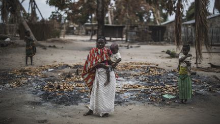 Une femme avec son enfant après l'attaque d'un village dans la province de Cabo Delgado dans l'extrême nord du Mozambique en août 2019. (MARCO LONGARI / AFP)