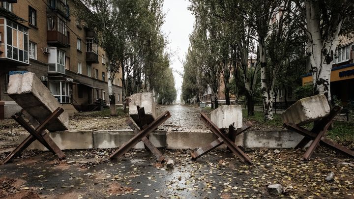 Des obstacles installés au milieu d'une rue du centre de Bakhmout (Ukraine), le 11 octobre 2022, sur la ligne de front avec les mercenaires de Wagner. (YASUYOSHI CHIBA / AFP)