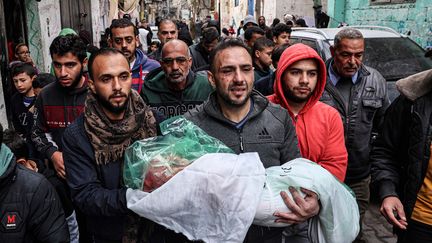 Un homme porte le corps de sa fille, tuée dans un bombardement israélien, lors de ses funérailles à Rafah, dans la bande de Gaza, le 17 janvier 2024. (AFP)