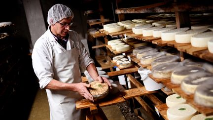 Un producteur de tome des Bauges en décembre 2019. (JEAN-PIERRE CLATOT / AFP)