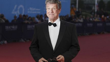 Le réalisateur américian John McTiernan sur le tapis rouge du 40e Festival du cinéma américain de Deauville (2014)
 (CHARLY TRIBALLEAU / AFP)