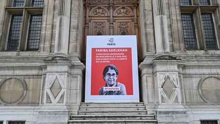 Une affiche avec le portrait de l'universitaire franco-iranienne Fariba Adelkhah, emprisonnée en Iran, est placée devant l'Hôtel de Ville à Paris, le 5 juin 2020 (photo d'illustration). (BERTRAND GUAY / AFP)