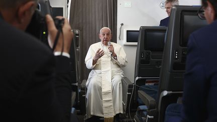 Pope Francis holds a news conference aboard the papal plane upon his return from a 12-day trip through Southeast Asia and Oceania, Sept. 13, 2024. (GUGLIELMO MANGIAPANE/POOL)