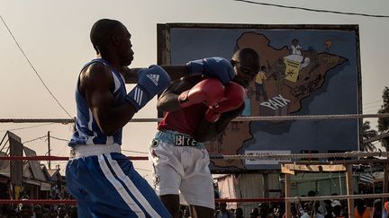 un panneau publicitaire affiche une immense carte de la Centrafrique parsemée de bonshommes armés, et barrée du mot Paix. Tout un symbole. (MARCO LONGARI / AFP)