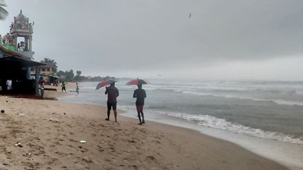 Des promeneurs marchent sur la plage de&nbsp;Trincomalee (Sri Lanka), le 2 décembre 2020. (REUTERS)