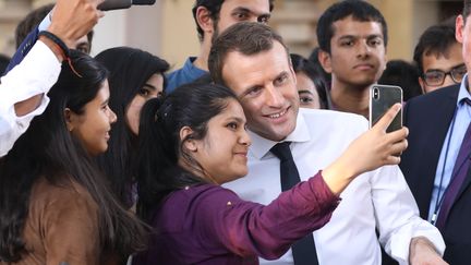 Le président de la République, Emmanuel Macron, pose pour un selfie avec des étudiants Indiens à New Delhi, le 10 mars 2018.&nbsp; (LUDOVIC MARIN / AFP)