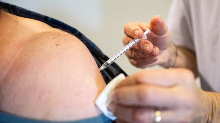 Une personne reçoit une troisième injection de vaccin contre le Covid-19, à Dinan (Côtes-d'Armor), le 18 décembre 2021. (MARTIN BERTRAND / HANS LUCAS / AFP)