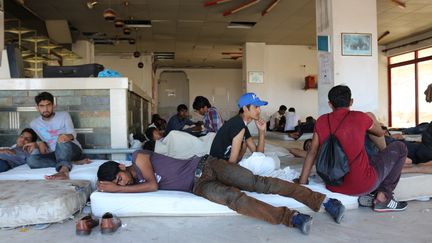 Les hommes dorment sur des matelas jet&eacute;s par terre dans ce qui &eacute;tait la r&eacute;ception d'un h&ocirc;tel d&eacute;saffect&eacute; &agrave; Kos (Gr&egrave;ce). (BENOIT ZAGDOUN / FRANCETV INFO)