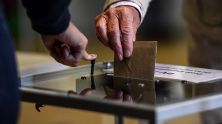 Un homme vote pour les élections municipales à Paris, le 28 juin 2020. (CHRISTOPHE ARCHAMBAULT / AFP)