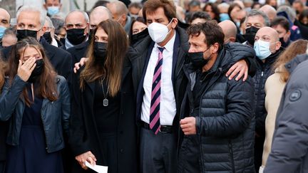 Max Guazzini, ancien président du Stade Français, enlasse de ses bras Loretta Denaro, veuve de Christophe Dominici, et Franck Comba, son ami de toujours lors des obsèques à Boulogne-Billancourt (THOMAS SAMSON / AFP)