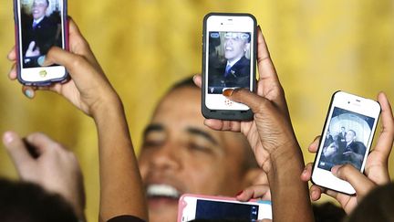 Le pr&eacute;sident am&eacute;ricain Barack Obama est pris en photo avec des iPhones lors d'une r&eacute;ception &agrave; la Maison Blanche &agrave; Washington (Etats-Unis), le 18 mars 2013. (JONATHAN ERNST / REUTERS)