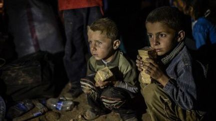 Sanliurfa (Turquie) le 21 septembre 2014 : Enfants kurdes syriens, attendant d'entrer dans la ville de Suruc au sud-est de la Turquie. 
 (AFP PHOTO/BULENT KILIC)