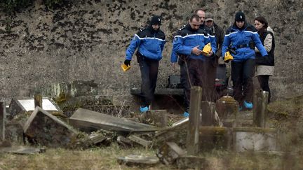 Des gendarmes enqu&ecirc;tent dans le cimeti&egrave;re juif de Sarre-Union (Bas-Rhin), le 16 f&eacute;vrier 2015, deux jours apr&egrave;s la d&eacute;couverte de la profanation de 250 tombes. (FREDERICK FLORIN / AFP)