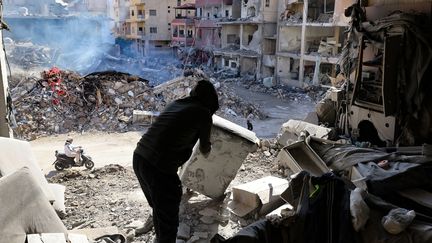 Un habitant dégage des décombres au milieu des destructions causées par les bombardements israéliens dans la ville de Tyr, dans le sud du Liban, le 28 novembre 2024, au lendemain de l'entrée en vigueur d'un cessez-le-feu entre Israël et le Hezbollah. (ANWAR AMRO / AFP)