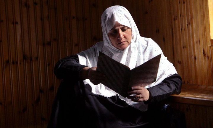 Femme de la minorité musulmane de Grèce, lisant le Coran dans une mosquée de Komotini, dans le nord-est du pays, le 17 octobre 2003. (FAYEZ NURELDINE / AFP)