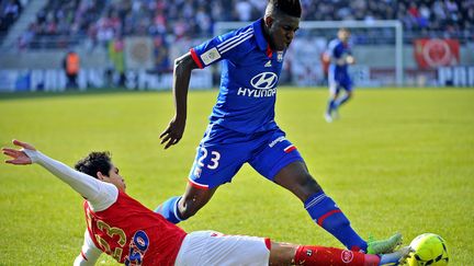 Le d&eacute;fenseur de Lyon Samuel Umtiti se heurte &agrave; la d&eacute;fense r&eacute;moise, le 7 avril 2013.&nbsp; (MAXPPP)