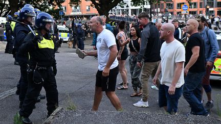 A protester walks towards riot police as clashes break out in Bristol on August 3, 2024 during the protest "Enough is enough"organised in response to the fatal stabbing in Southport on July 29. (JUSTIN TALLIS / AFP)