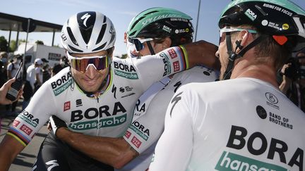 Peter Sagan (à g.), félicité par Daniel Oss (au milieu) et Maciej Bodnar lors du Tour d'Italie 2021. (FABIO FERRARI / POOL / AFP)