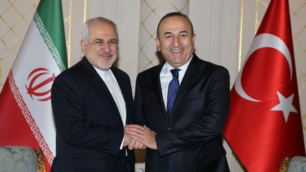 Le ministre des Affaires étrangère iranien, Javad Zarif, et son homologue turc, Mevlut Cavusoglu, retrouvent le sourire en parlant affaires, le 19 mars 2016 à Téhéran. (Abdulhamid Hosbas/Anadolu Agency/AFP)