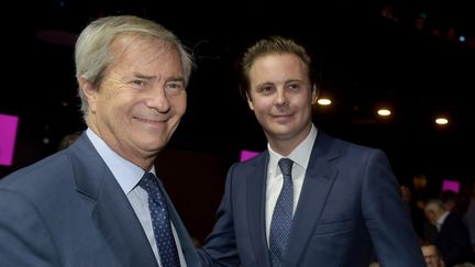 Vincent Bolloré (à gauche) et son fils Cyrille Bolloré (à droite) à Paris, le 19 avril 2018.&nbsp; (ERIC PIERMONT / AFP)