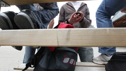 Le téléphone portable, déjà interdit en classe, pourrait l'être aussi dans les cours des récréations et collèges (illustration). (MAXPPP)