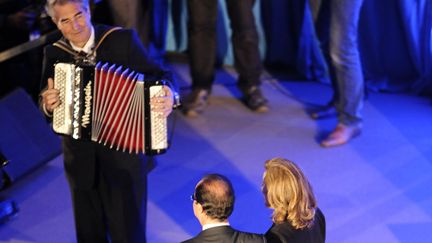 Fran&ccedil;ois Hollande et sa compagne Val&eacute;rie Treiweiler sur la sc&egrave;ne &agrave; Tulle (Corr&egrave;ze). (JEAN-PIERRE MULLER / AFP)