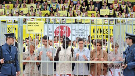 Des militants d'Amnesty International interprètent un tableau humain illustrant la détention arbitraire, en mai 2008, à Paris. (MIGUEL MEDINA / AFP)