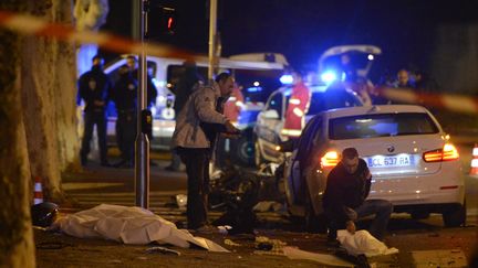 Des policiers font des relev&eacute;s sur les lieux de l'accident o&ugrave; un motard est mort percut&eacute; par une voiture vol&eacute;e &agrave; Marseille, le 1er d&eacute;cembre 2012. (ANNE-CHRISTINE POUJOULAT / AFP)