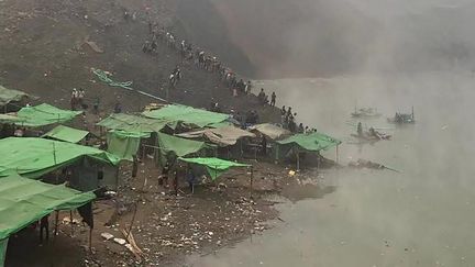 Des sauveteurs à la recherche&nbsp;de mineurs disparus après un glissement de terrain dans une mine en Birmanie, le 22 décembre 2021. (STR / AFP)