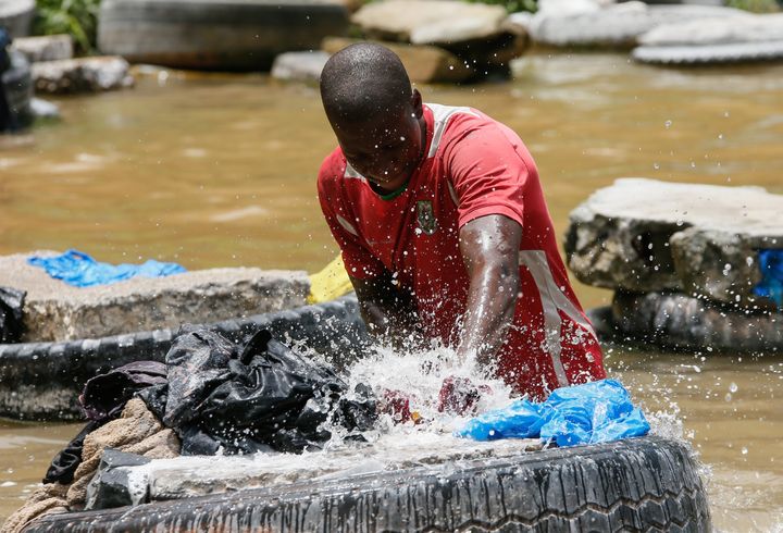 Un fanico en plein effort frappe le linge sur un pneu placé au milieu de la rivière. (MAHMUT SERDAR ALAKUS / ANADOLU AGENCY)