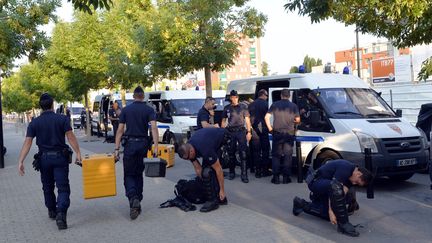 Des policiers s'&eacute;quipent au lendemain d'importantes violences &agrave; Trappes (Yvelines), le 20 juillet 2013. (MIGUEL MEDINA / AFP)