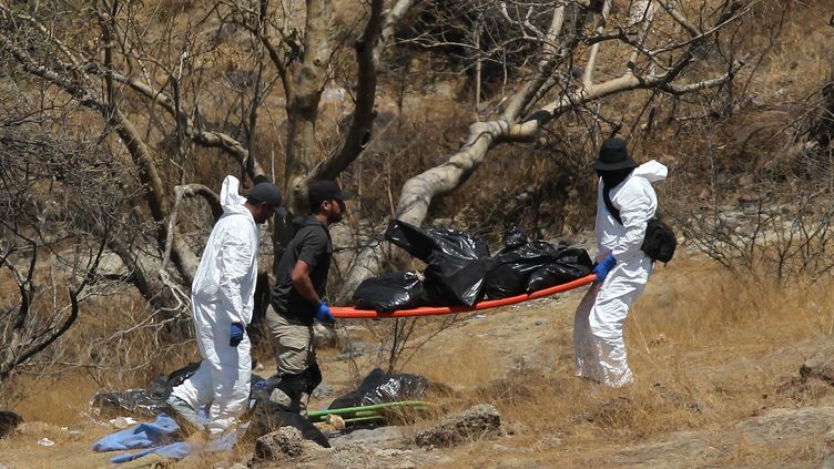 Investigators carry bags containing human remains to Zapopan in Mexico on May 31, 2023. (ULISES RUIZ / AFP)