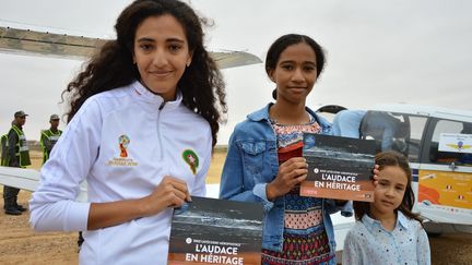 confie toute fière Hiba, 12 ans, avant son baptême de l'air depuis la piste de sable de Tarfaya, dans le désert marocain. Cette escale mythique de l'Aéropostale aurait inspiré à Saint-Exupéry son célèbre «Petit Prince». Derrière elle, le bruit vrombissant des moteurs rythme le ballet continu des avions qui atterrissent. Une poignée d'enfants se massent près des barrières, dans l'espoir d'approcher les Cessna, Piper et autres Robin.
 (Clément MELKI / AFP)