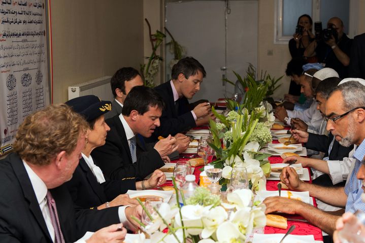 Le ministre de l'Int&eacute;rieur, Manuel Valls, d&icirc;ne en pr&eacute;sence de musulmans qui rompent le ramadan, &agrave; la mosqu&eacute;e d'Ozoir-la-Ferri&egrave;re (Seine-et-Marne), le 1er ao&ucirc;t 2013. (BERTRAND LANGLOIS / AFP)