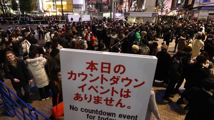 Malgré les demandes des autorités de ne pas se rassembler, plusieurs centaines de personnes sont venues accueillir 2021 au carrefour de Shibuya, à Tokyo (Japon). (MASANORI INAGAKI / YOMIURI / AFP)